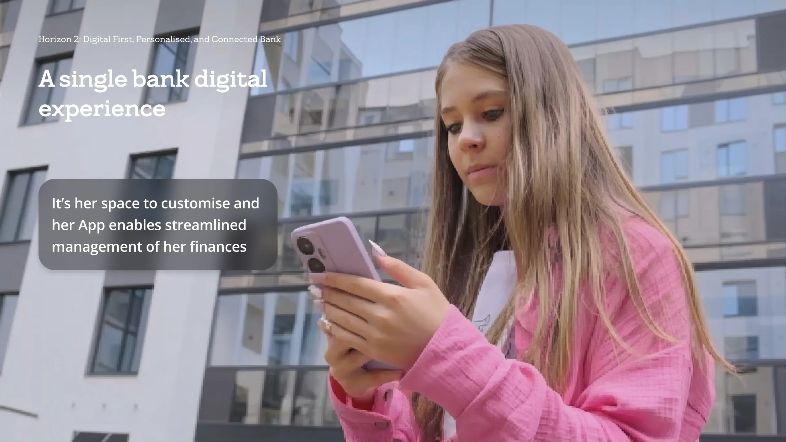 Aisling using her banking app outside a modern building