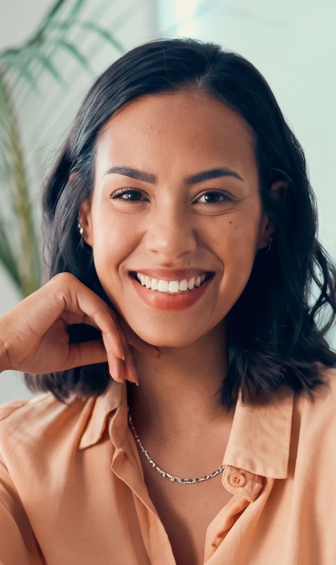 A smiling customer resting her chin on her hand