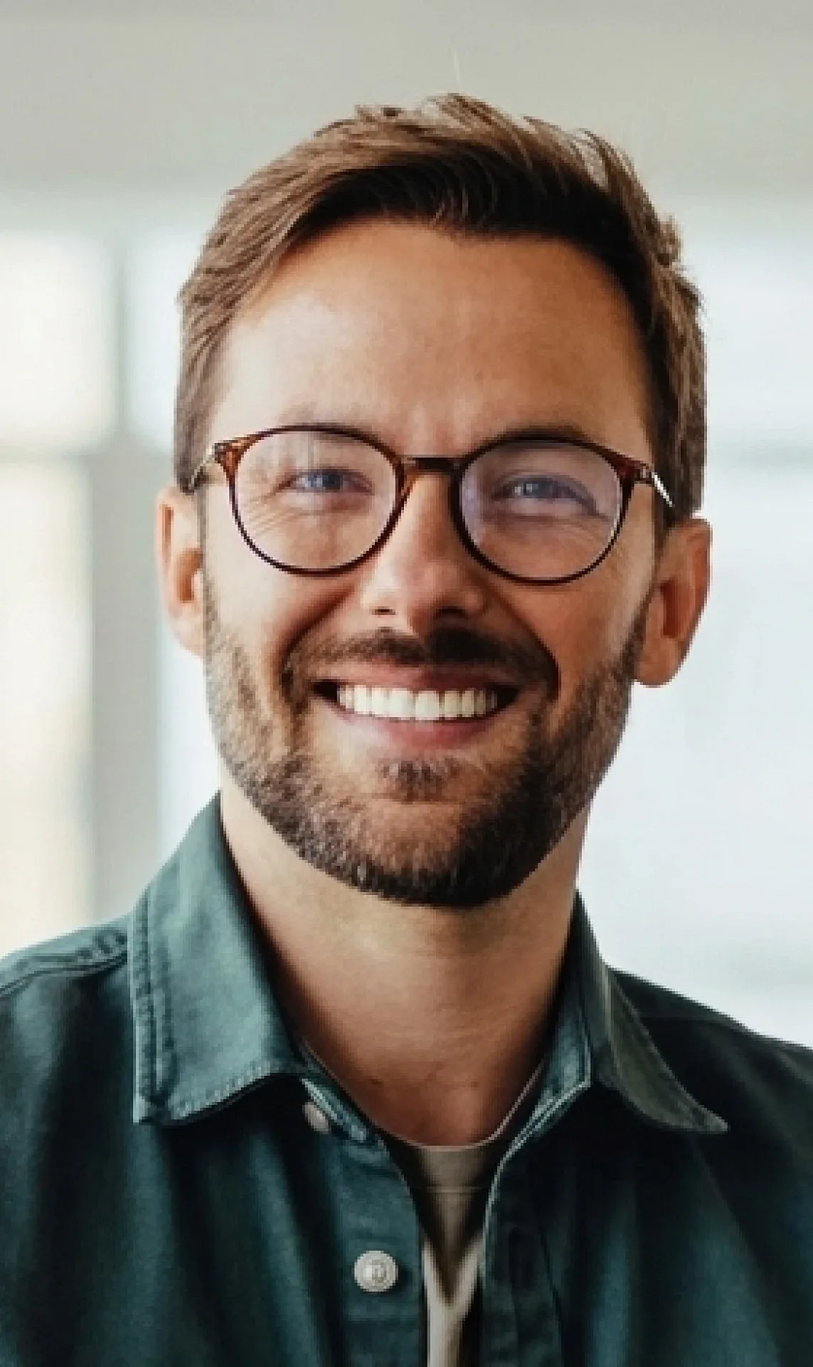 A smiling business owner in glasses